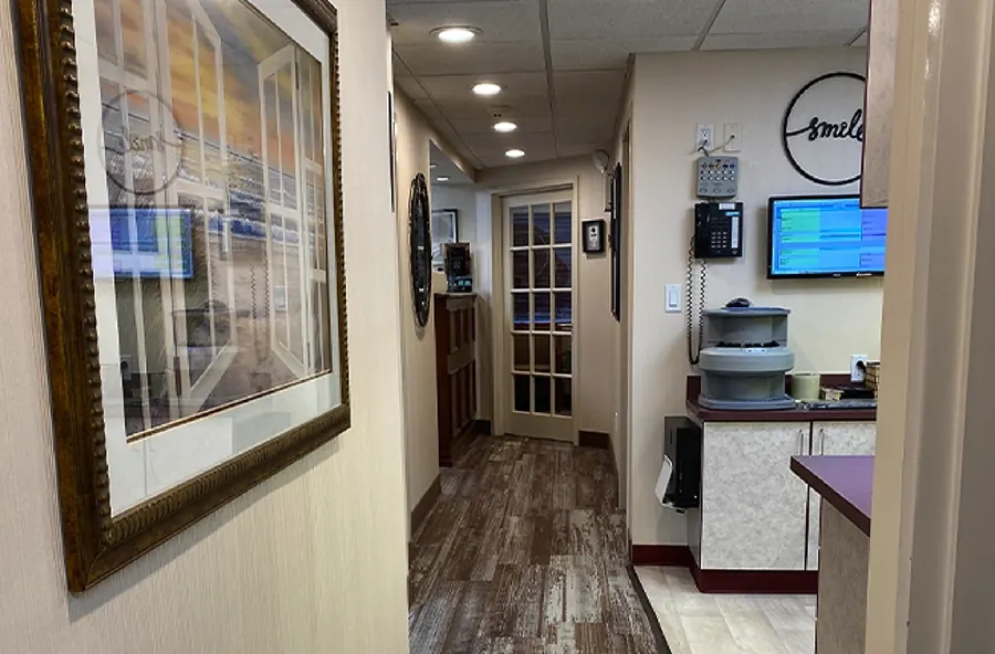 The corridor to the treatment rooms, with the practice's smile sign on the wall.