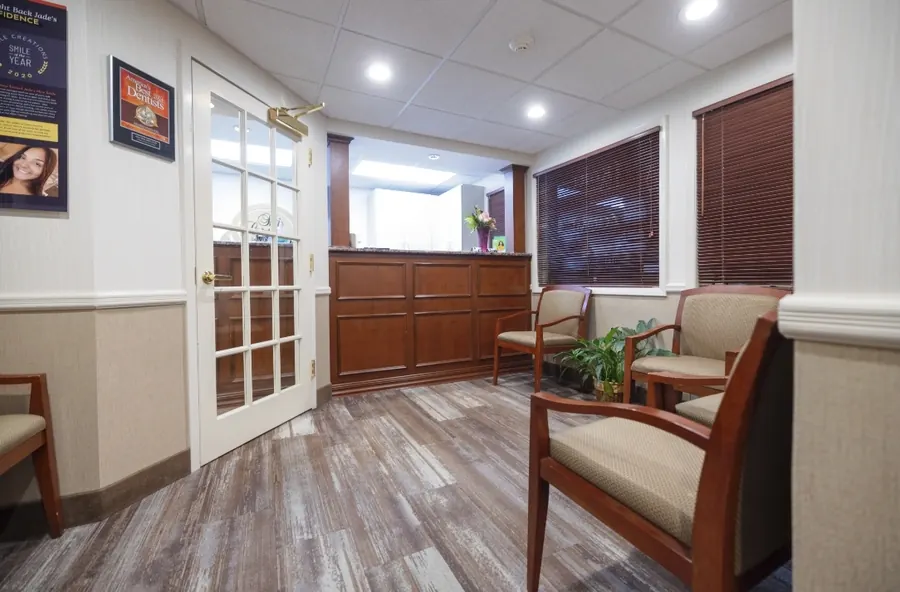 The entrance hall, with French doors and wood-paneled reception.