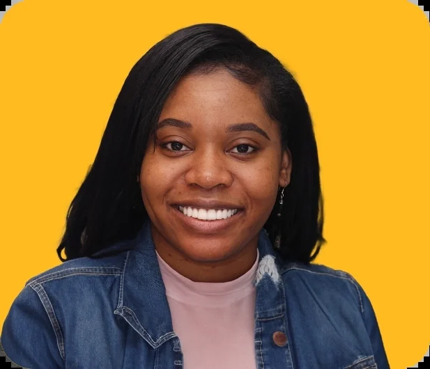 Chanique, a Smile Creations patient, smiling against a yellow background.