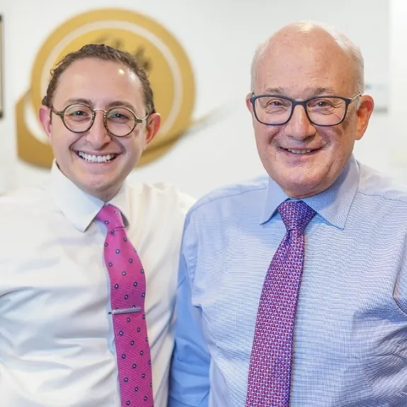 Dr. Ariel Steinberger and Dr. Allan S. Mohr standing together and smiling in the office.