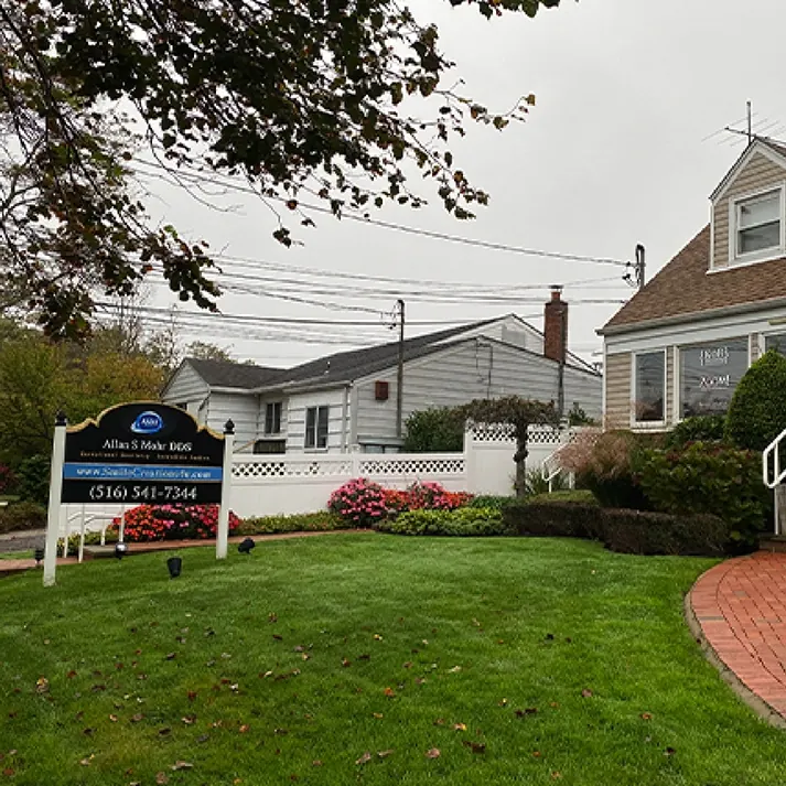 The Smile Creations building on Block Blvd, with the practice sign on the front lawn.